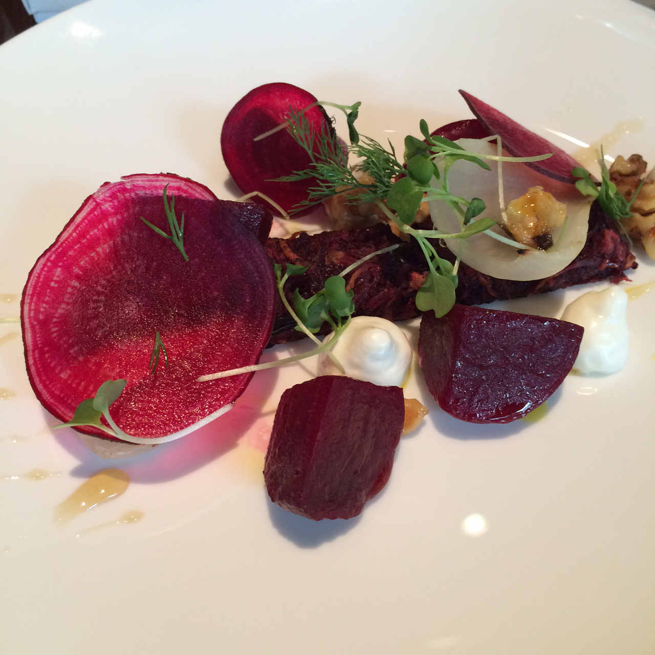 Beetroot and potato cake with goat cheese, sweet and sour honey and walnuts