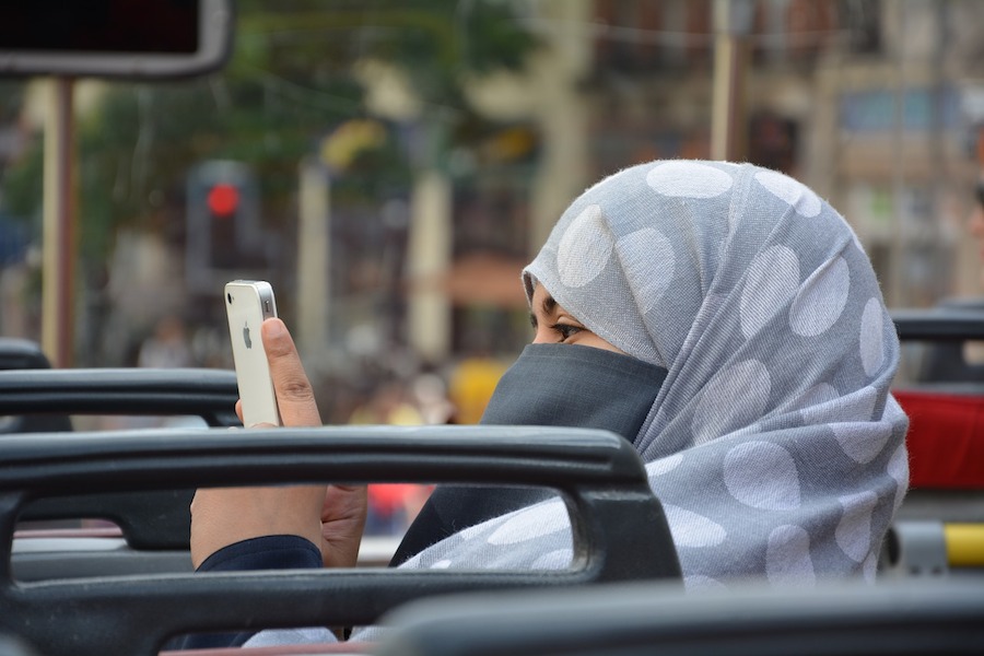 Muslim woman on iPhone