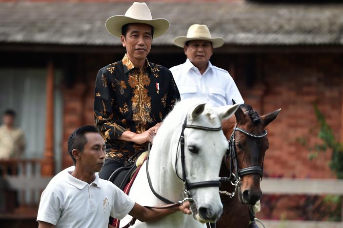 President Jokowi horse riding with Prabowo Subianto. Photo: Reuters