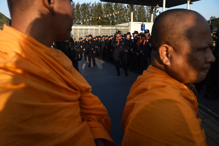 Buddhist monks face the police in front of Wat Dhammakaya temple, February 16, 2017.  Photo: Lilian Suwanrumpha/ AFP