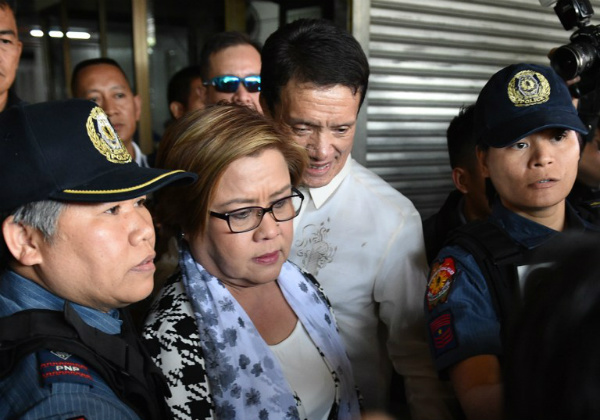 Senator Leila De Lima is escorted by police officers and her lawyer Alex Padilla after her arrest at the Senate. PHOTO: AFP