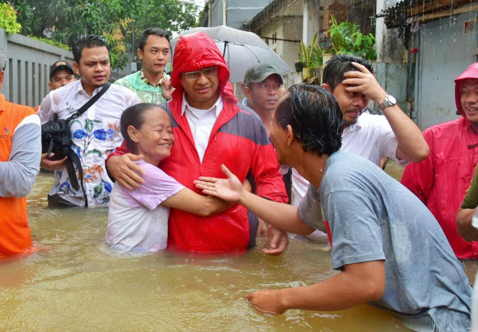 Then-Jakarta gubernatorial candidate Anies Baswedan (Red raincoat) visiting a flood location in Cipinang Melayu, East Jakarta in February 2017. Photo: Twitter / @partaigerindra