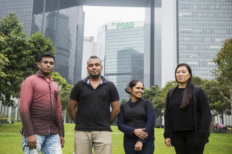 (L-R) Sri Lankan refugee Ajith Puspa, Sri Lankan refugee Supun Thilina Kellapatha, 32, his partner Nadeeka, 32, and Filipino refugee Vanessa Rodel, 40, pose for a photo in front of the government buildings of Hong Kong on February 23, 2017, after attending a press conference. Photo: Isaac Lawrence/AFP