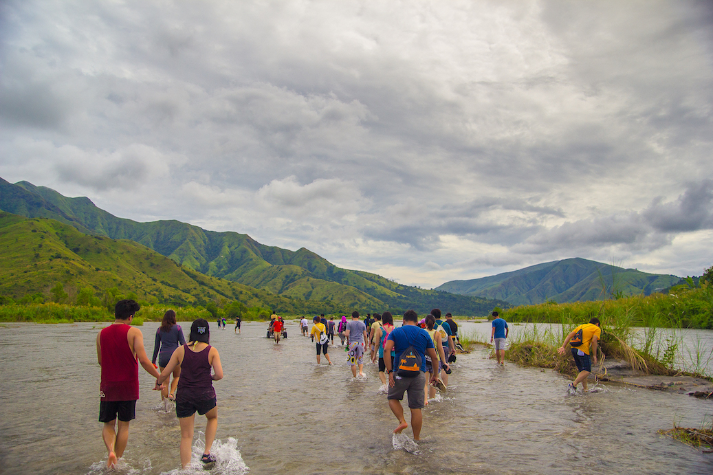 ‘Voluntourists’ cross rivers and lahar to get to Sitio Yangil in San Felipe, Zambales. PHOTO: Ching Dee