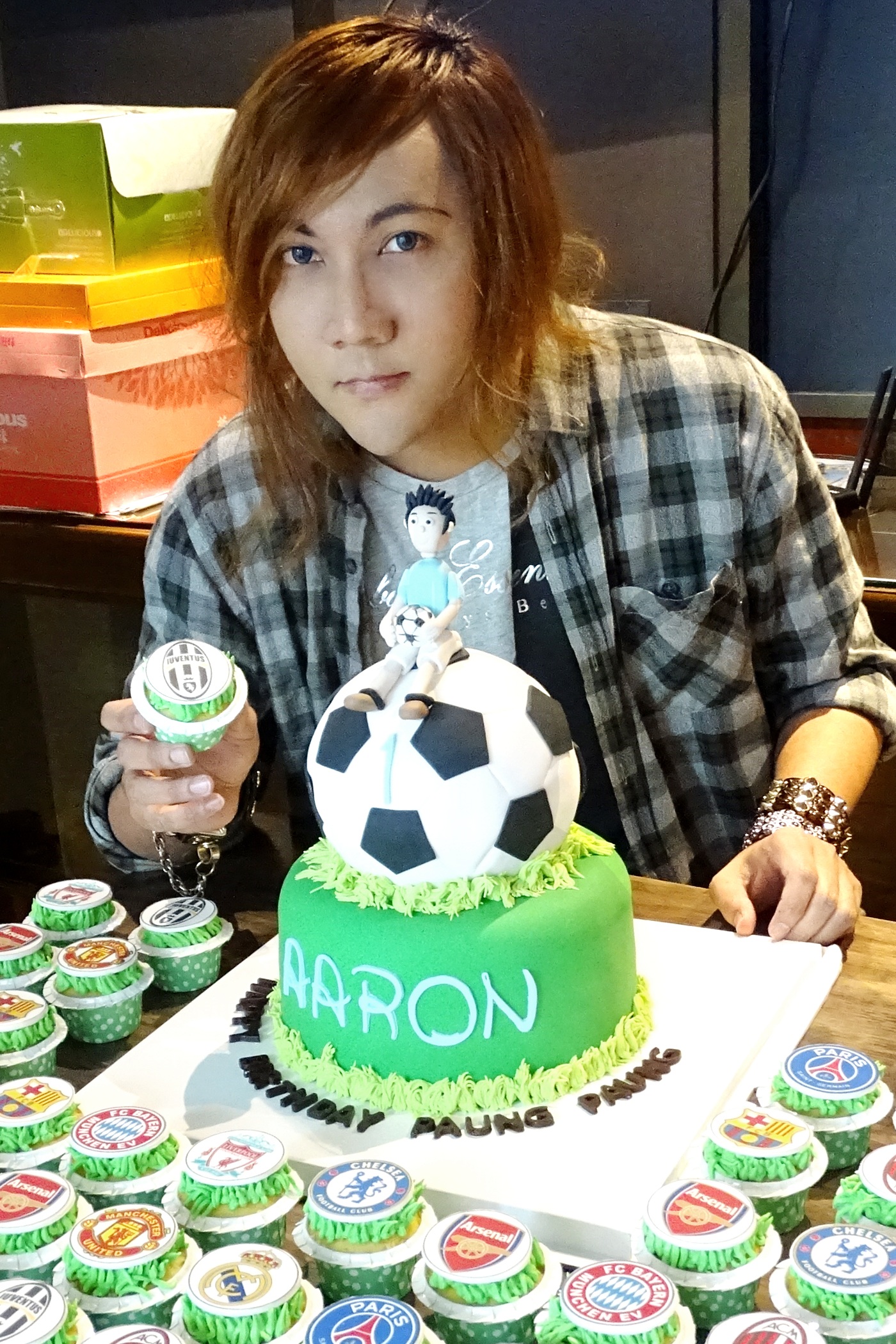 Phyo Han Kyaw with a football-themed cake and cupcake order.