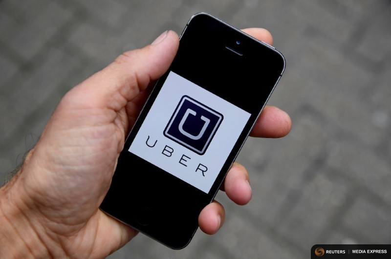 The Uber logo is seen on a mobile phone. Illustration: Toby Melville/ Reuters