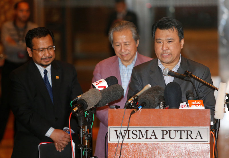 Mohd Nor Azrin Md Zain, counsellor at Malaysia's embassy in Pyongyang, addresses the media with Malaysia's Foreign Minister Anifah Aman and Malaysia's ambassador to North Korea Mohamad Nizan Mohamad at the Kuala Lumpur International Airport in Sepang