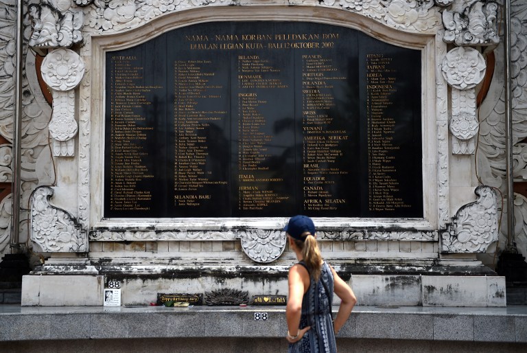 A foreign tourist looks at the name of victims on a monument for the Bali bombing at Kuta near Denpasar, on Indonesia’s resort island of Bali on March 23, 2017. Photo: Sonny Tumbelaka/AFP