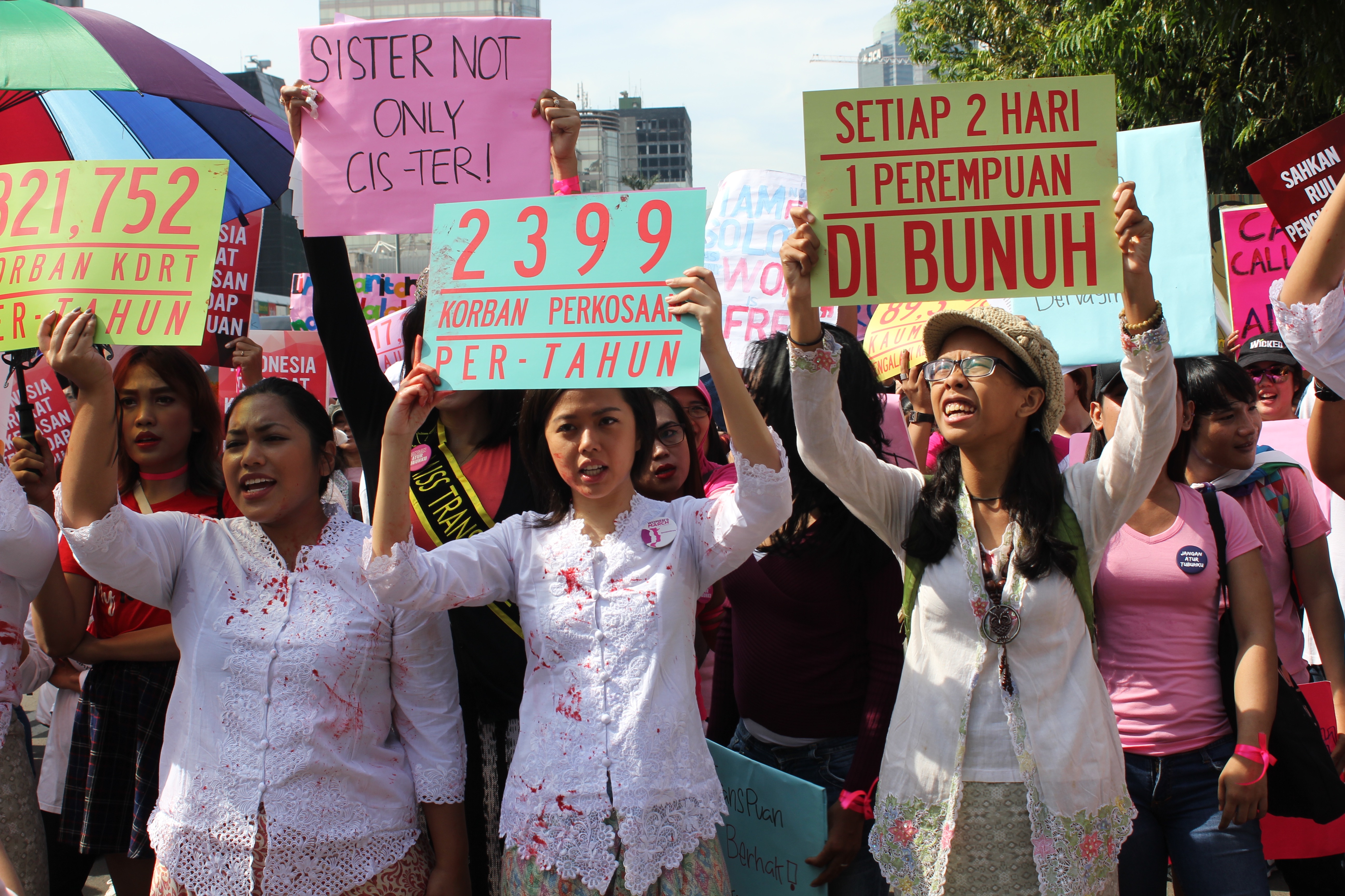 Activists holding up signs during Jakarta Women’s March on March 4, 2017.  Many of the same people behind the Jakarta Women’s March have organized this weekend’s Feminist Fest. Photo: Coconuts Media / Andra Nasrie