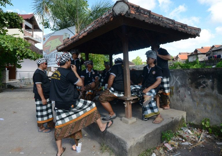Balinese guards prepare to patrol a residential area in Jimbaran district as the Indonesian holiday island shut down for a day of silence to mark Nyepi, the Hindu new year on March 31, 2014. Retailers closed their shops and many tourists stayed inside their hotels for a day of reflection that is supposed to be free from daily routine, including work and play. Guards with sticks and traditional daggers enforced the public observance among the Hindu- majority population. Photo: Sonny Tumbelaka/AFP