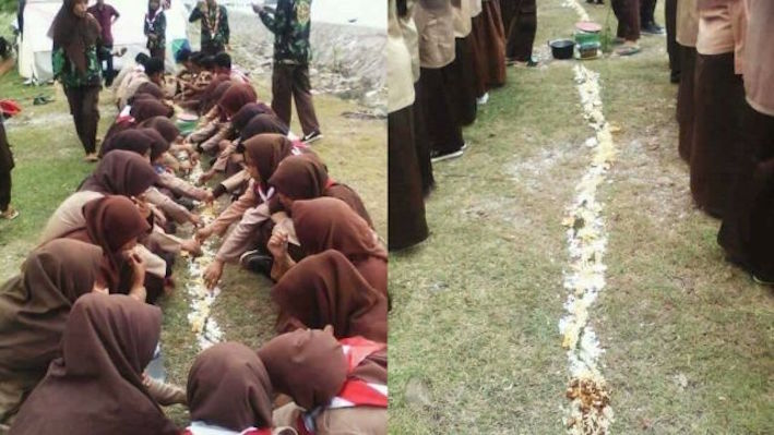 Members of Pramuka (Indonesian Scouts) forced to eat off the ground as punishment. Photo: Facebook
