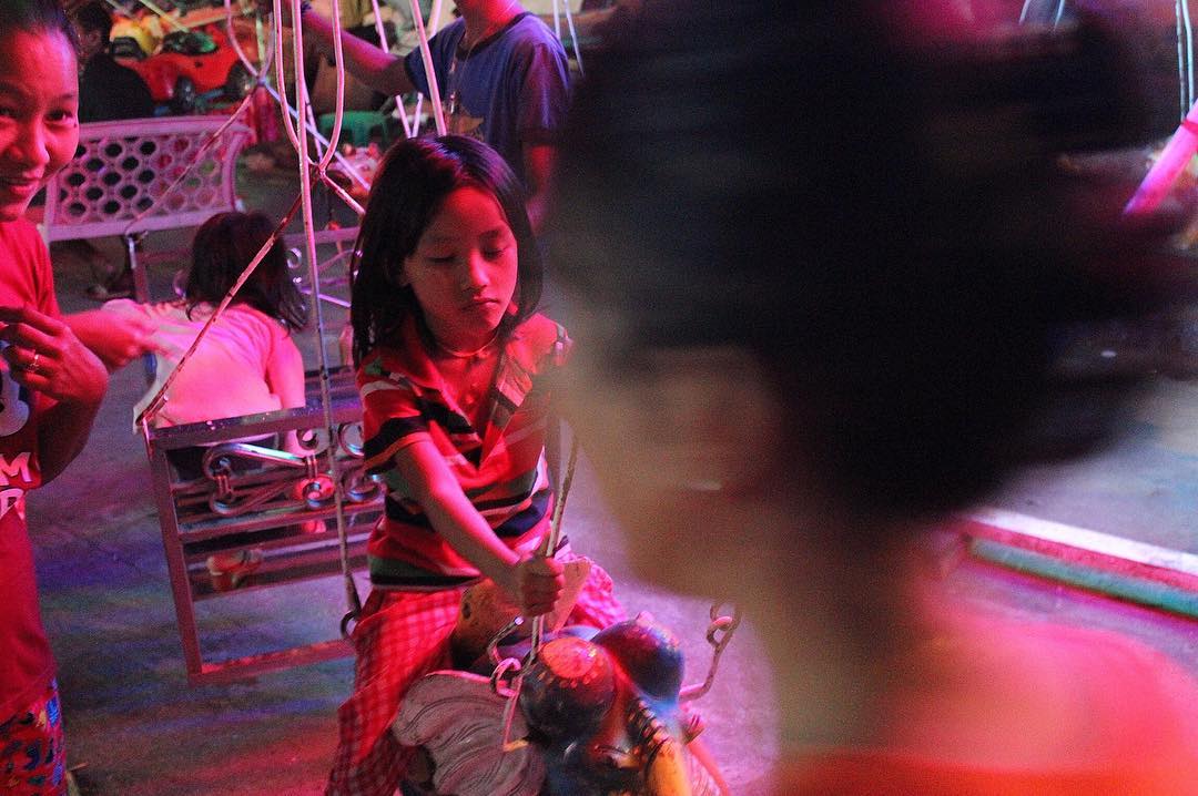 A child rides a carousel in Sanchaung. Photo: Jacob Goldberg