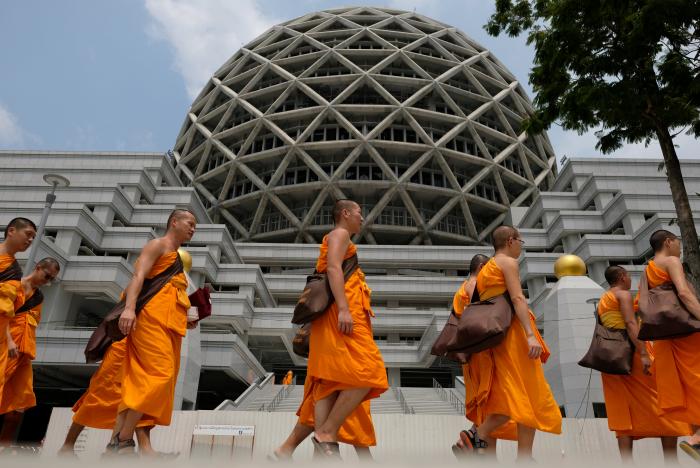 Buddhist Monks from Dhammakaya temple walk past a building inside Dhammakaya temple in Pathum Thani. Photo: Reuters