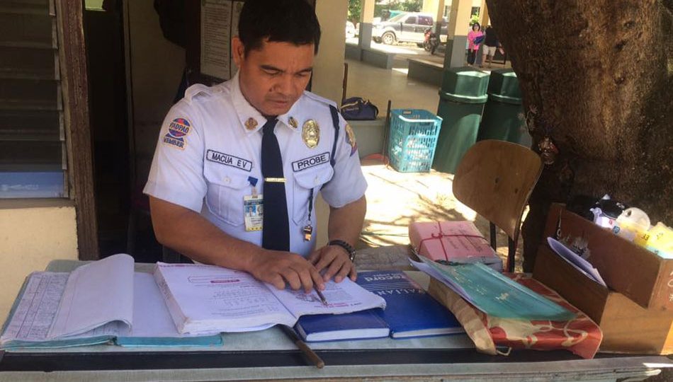 Erwin Macua, a security guard at St. Theresa’s College in Cebu City, will graduate cum laude this week. PHOTO: ABS-CBN News / Annie Perez