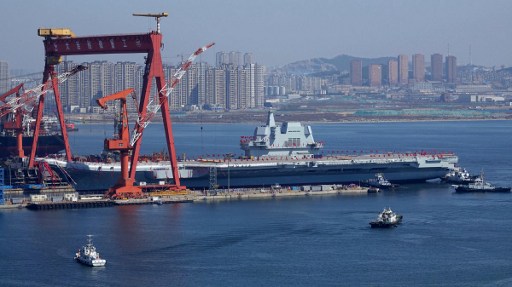 Type 001A, China’s second aircraft carrier, is transferred from the dry dock into the water during a launch ceremony at Dalian shipyard in Dalian, northeast China’s. Photo by AFP