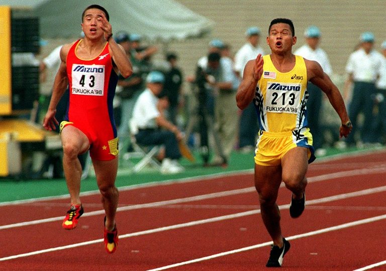 Zhou Wei of China (L) and Watson Nyambek of Malaysia dash to the goal for the men’s 100 meters at the 12th Asian Athletic Championships in Fukuoka, western Japan 20 July.  Zhou Wei won the gold with a time of 10.39 seconds and Nyambek won the silver with 10.42 seconds.        