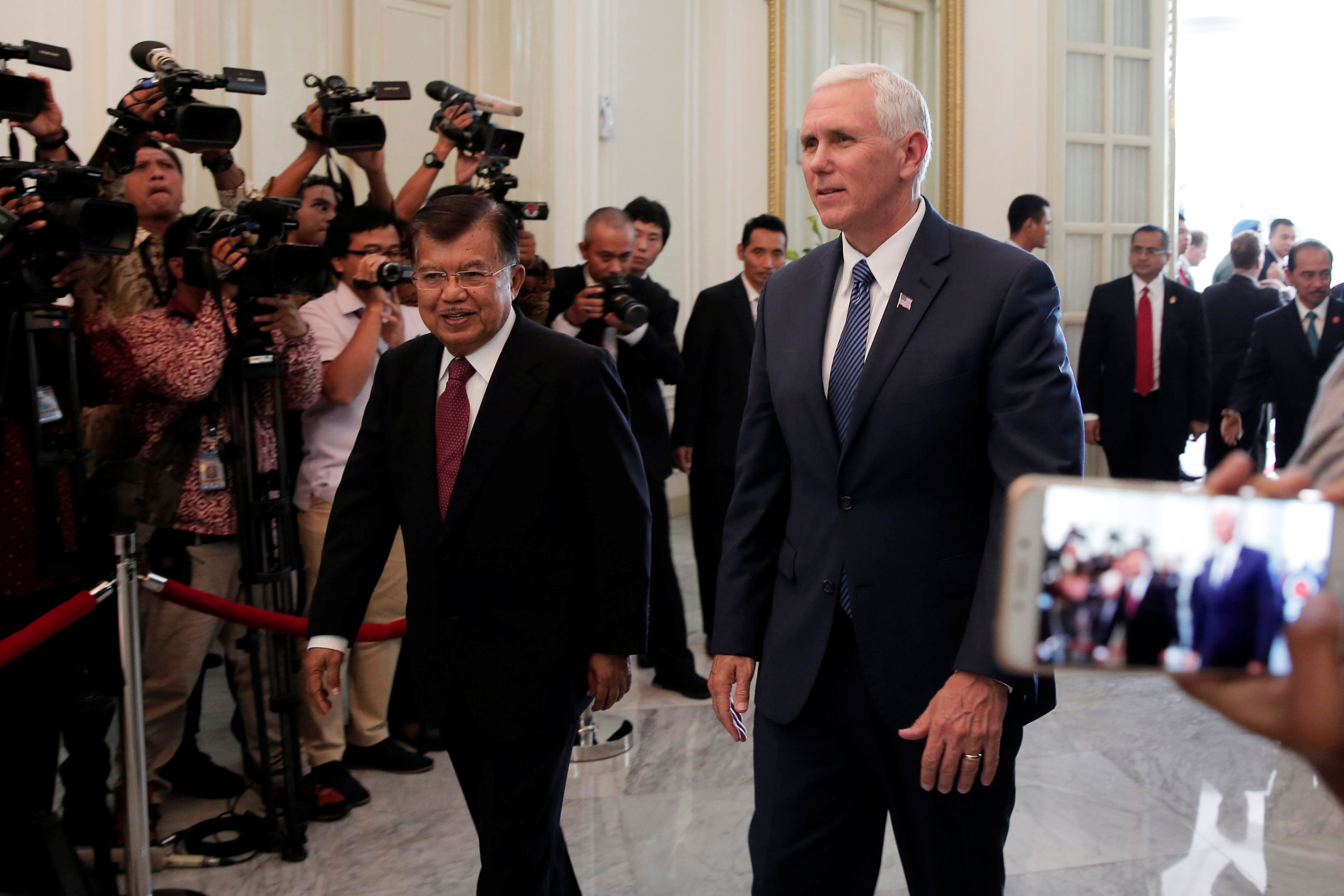 U.S. Vice President Mike Pence (R) walks with Indonesia’s Vice President Jusuf Kalla at the Vice President office in Jakarta, Indonesia April 20, 2017. REUTERS/Beawiharta
