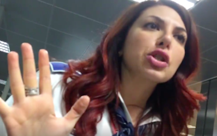 An airport security officer in Rome demanding that Aghnia remove her hijab for security check. Photo: Video screengrab