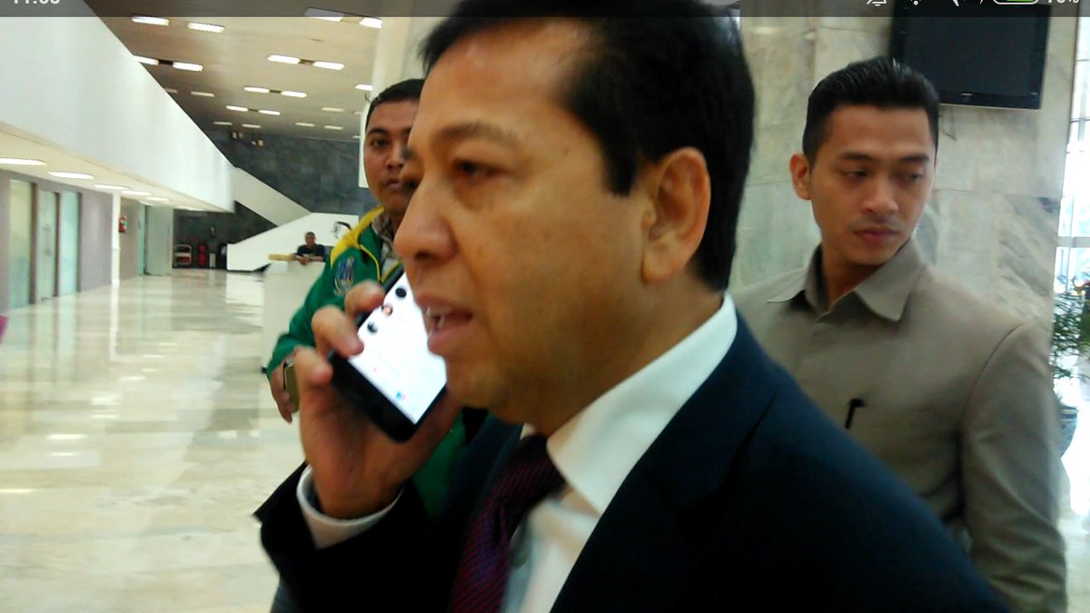 Indonesian House Speaker Setya Novanto on the phone while dodging reporters on April 12, 2017. His phone shows the WhatsApp chat selection screen still open, leading some to suggest he was faking the call to avoid questions. Photo: Twitter/@reporterjail