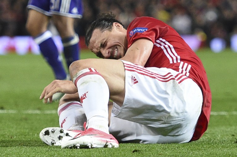 Manchester United’s Swedish striker Zlatan Ibrahimovic reacts after falling awkwardly during the UEFA Europa League quarter-final second leg football match between Manchester United and Anderlecht at Old Trafford in Manchester, north west England, on April 20, 2017. Photo: Oli Scarff/AFP