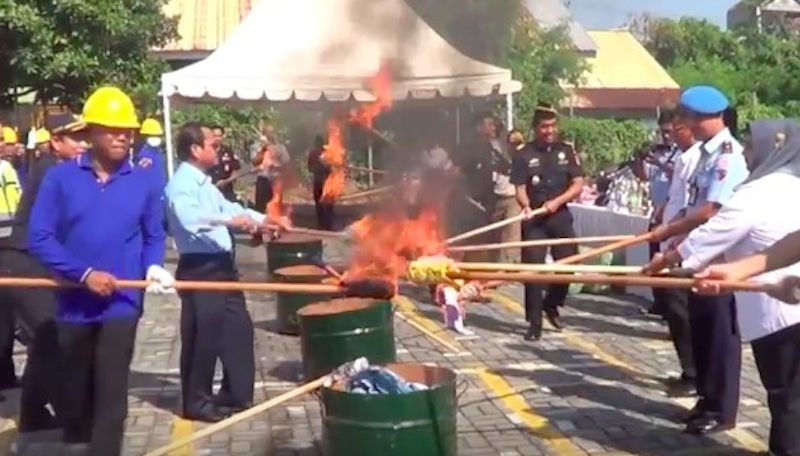 Customs officers light up hundreds of illegal goods confiscated in Bali. Photo: Still from YouTube