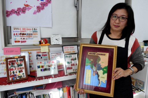 This picture taken on February 21, 2017, shows Nonnon, a 47-year-old Myanmar refugee and nail artist, holding a map of Myanmar at a nail salon in Tokyo.
Anti-refugee sentiment is rising in Europe and the United States but in Japan those seeking haven from tyranny and war have long faced daunting legal and social gauntlets. One of the world’s wealthiest countries, Japan accepted just 28 refugees in 2016 – one more than the previous year – out of the 8,193 applications reviewed by the Immigration Bureau. / AFP PHOTO / Toshifumi KITAMURA