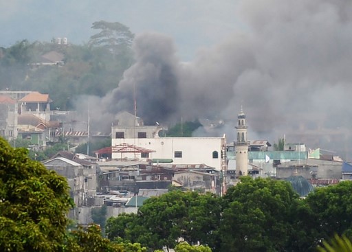 Smoke rises near a public market after military attack on the Maute terrorist group/ AFP PHOTO / TED ALJIBE