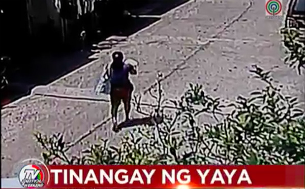 The suspect carrying the baby rode a tricycle and went to the nearest bust station.  PHOTO: Screen grab from  ABS-CBN News