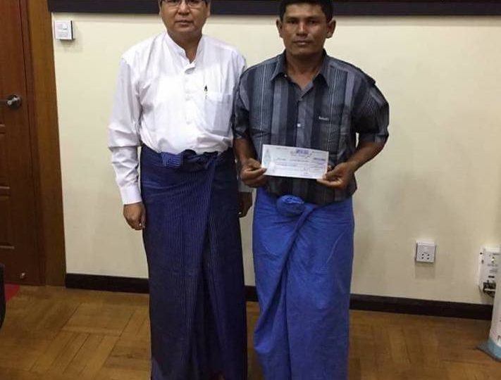 Aye Tun (R) with his largest lottery prize cheque to date (and probably ever). Photo: Facebook / T T Aung Aung