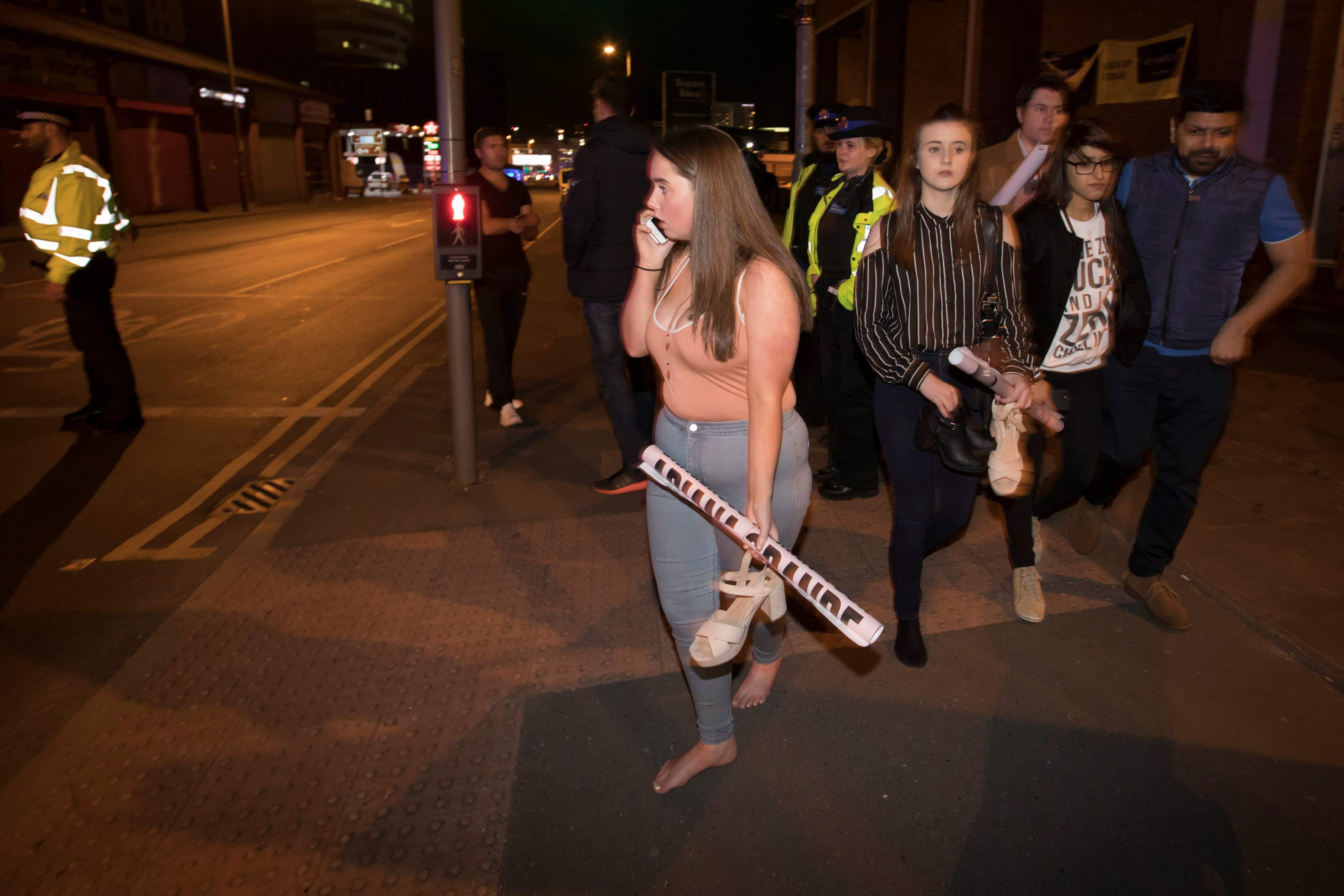 Concert goers react after fleeing the Manchester Arena in northern England where U.S. singer Ariana Grande had been performing in Manchester. Photo: Jon Super / Reuters
