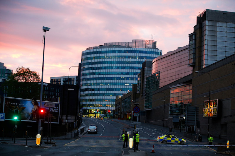The sun rises as police stand guard outside the Manchester Arena. Photo: Andrew Yates / REUTERS