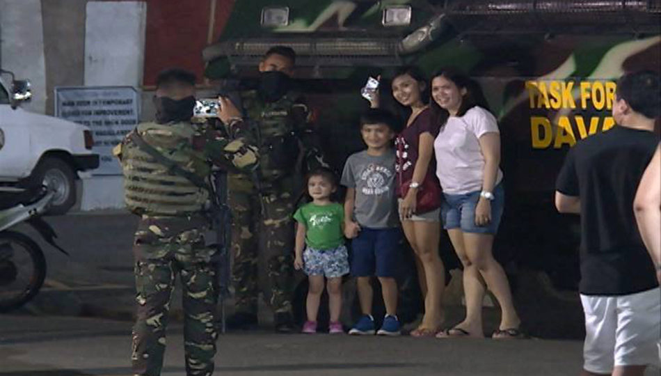 A family poses with a soldier in Davao City under martial law. PHOTO: ABS-CBN News