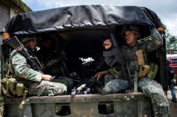 Government troops aboard their truck arrive to reinforce their colleagues in Marawi, PHOTO:  Noel Celis/AFP