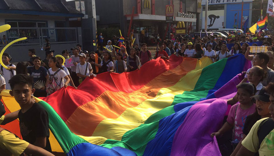 Members of the LGBTQ+ community wave the rainbow flag on Saturday’s Pride March 2017. PHOTO: ABS-CBN News