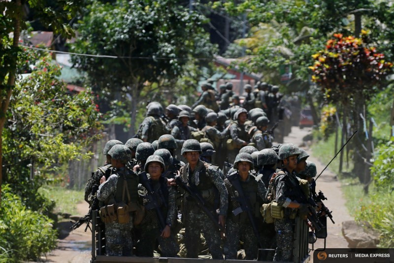 Philippines army soldiers ride in trucks into the fighting zone as government troops continue their assault against insurgents from the Maute group in Marawi City, Philippines June 28, 2017. REUTERS/Jorge Silva