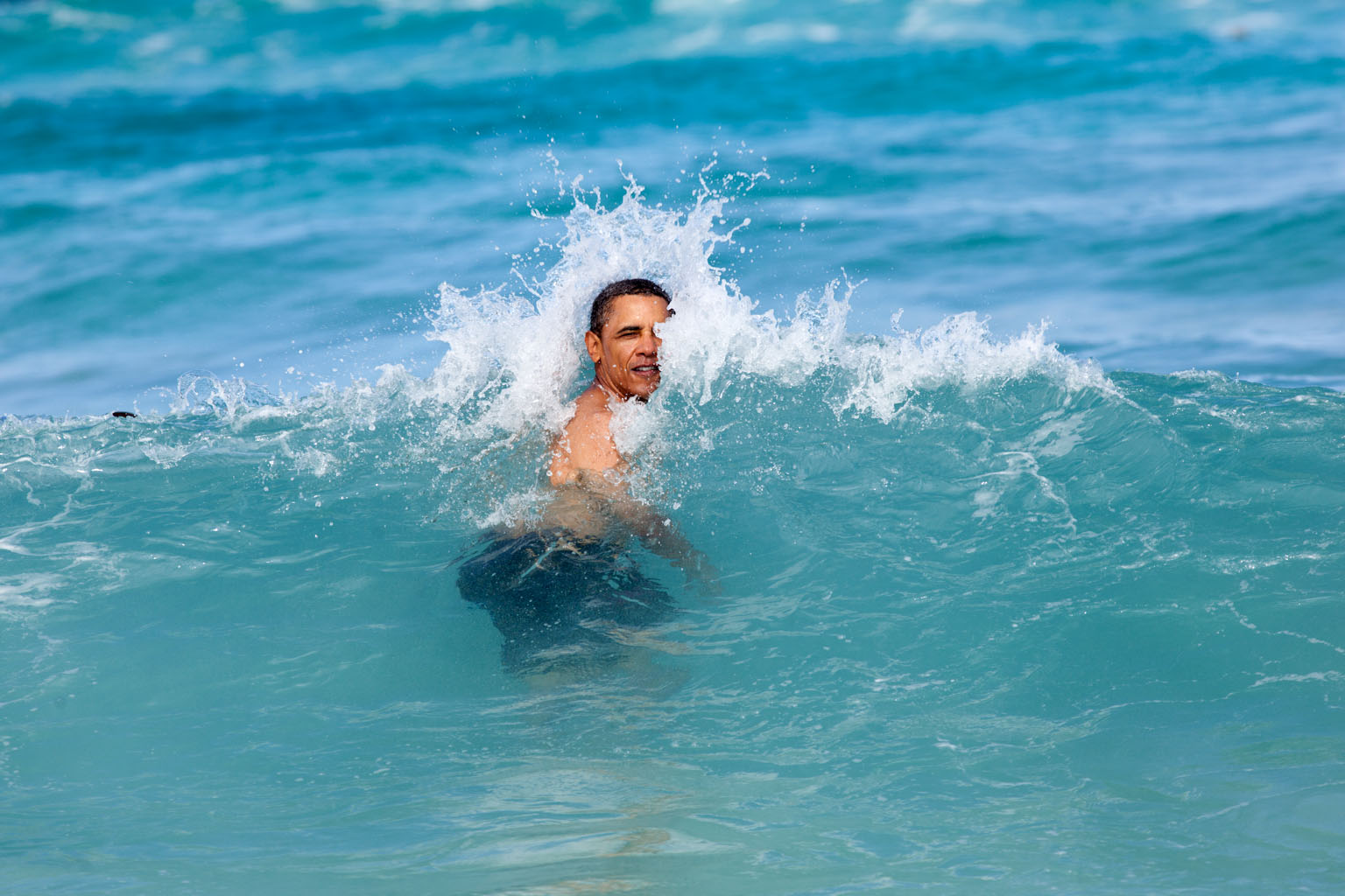 United States President Barack Obama swimming at Pyramid Rock Beach in Kaneohe Bay on New Year’s Day, 2012, during his annual Christmas holiday with family and friends. PHOTO: Official White House image via Wikimedia Commons