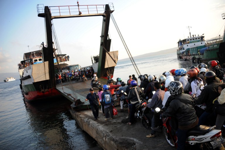 People on motorcycles queue to board a ferry headed for Java island, in Gilimanuk port on the island of Bali on August 17, 2012. Photo: Sonny Tumbelaka/AFP