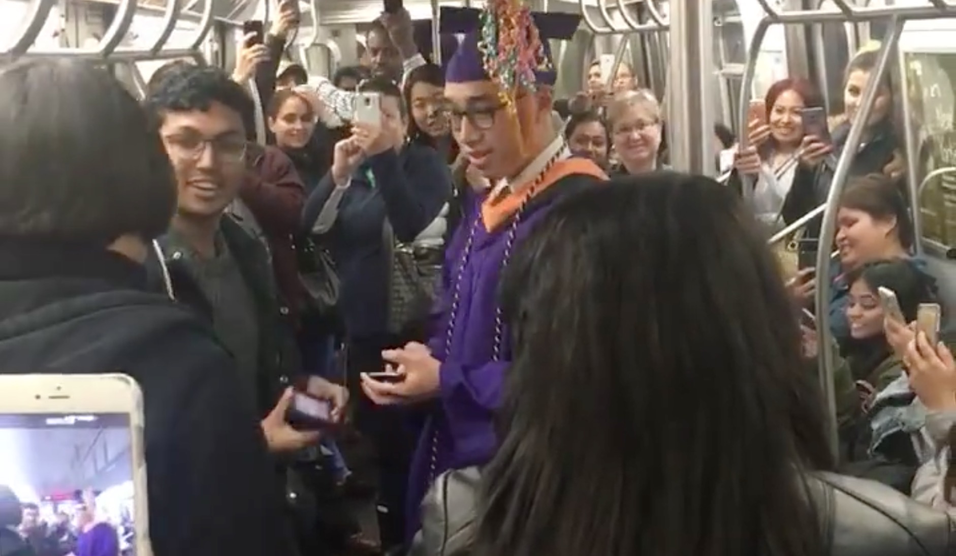 Fil-Am Jerick Alcantara graduates inside a subway train in New York City. PHOTO: Screengrab from Facebook video