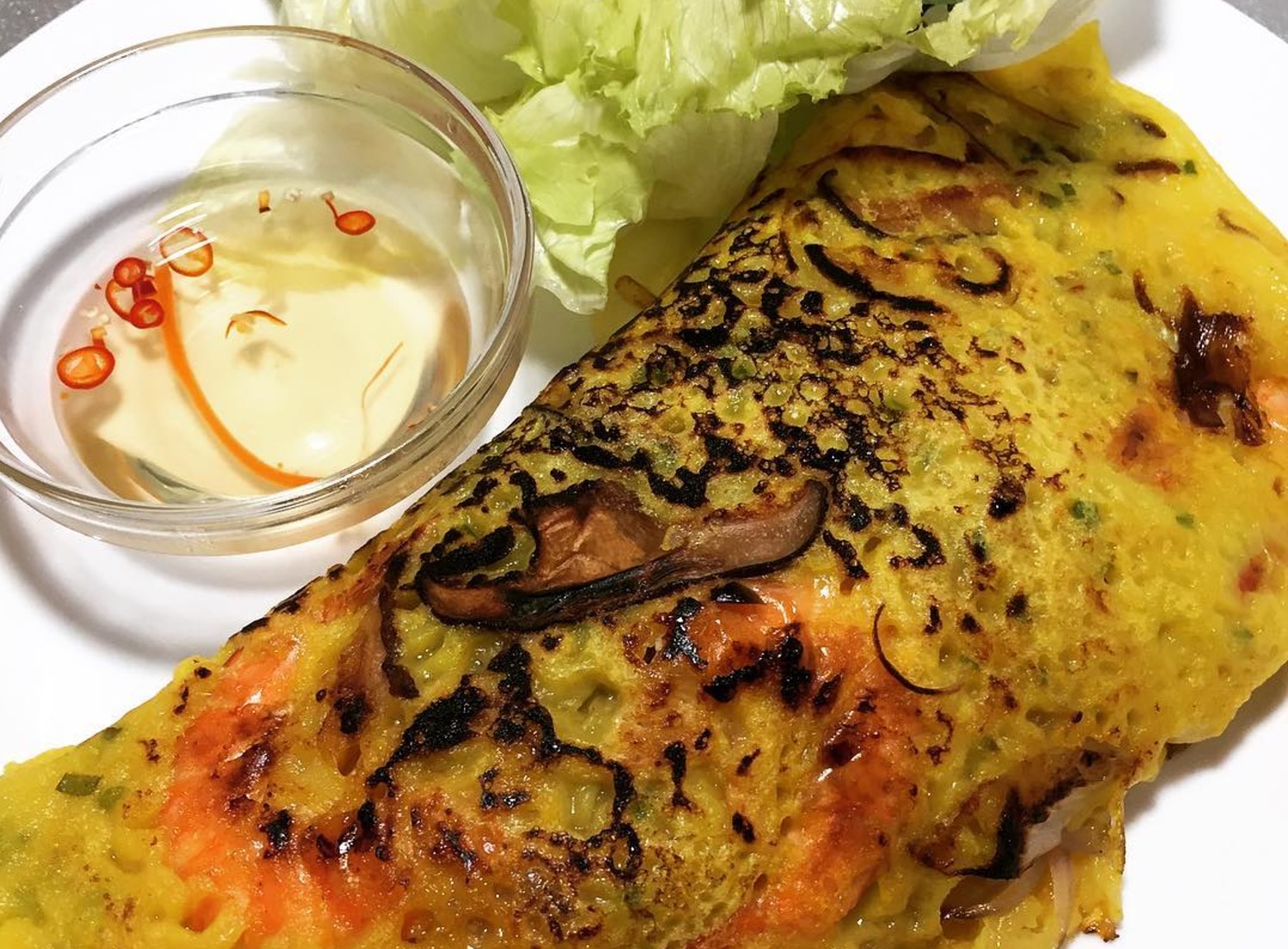 Chef Mai Pham’s Vietnamese Banh Xeo or sizzling crepe with shrimp and pork. PHOTO: Ching Dee