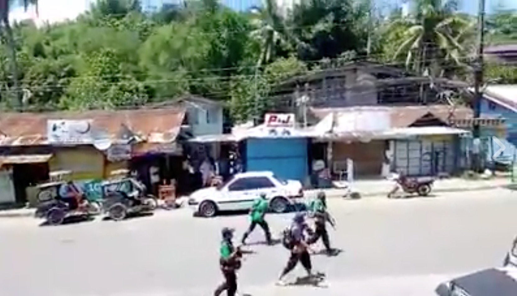 Armed men roaming the streets of Maasin, Iloilo. PHOTO: Screengrab from RMN Iloilo footage
