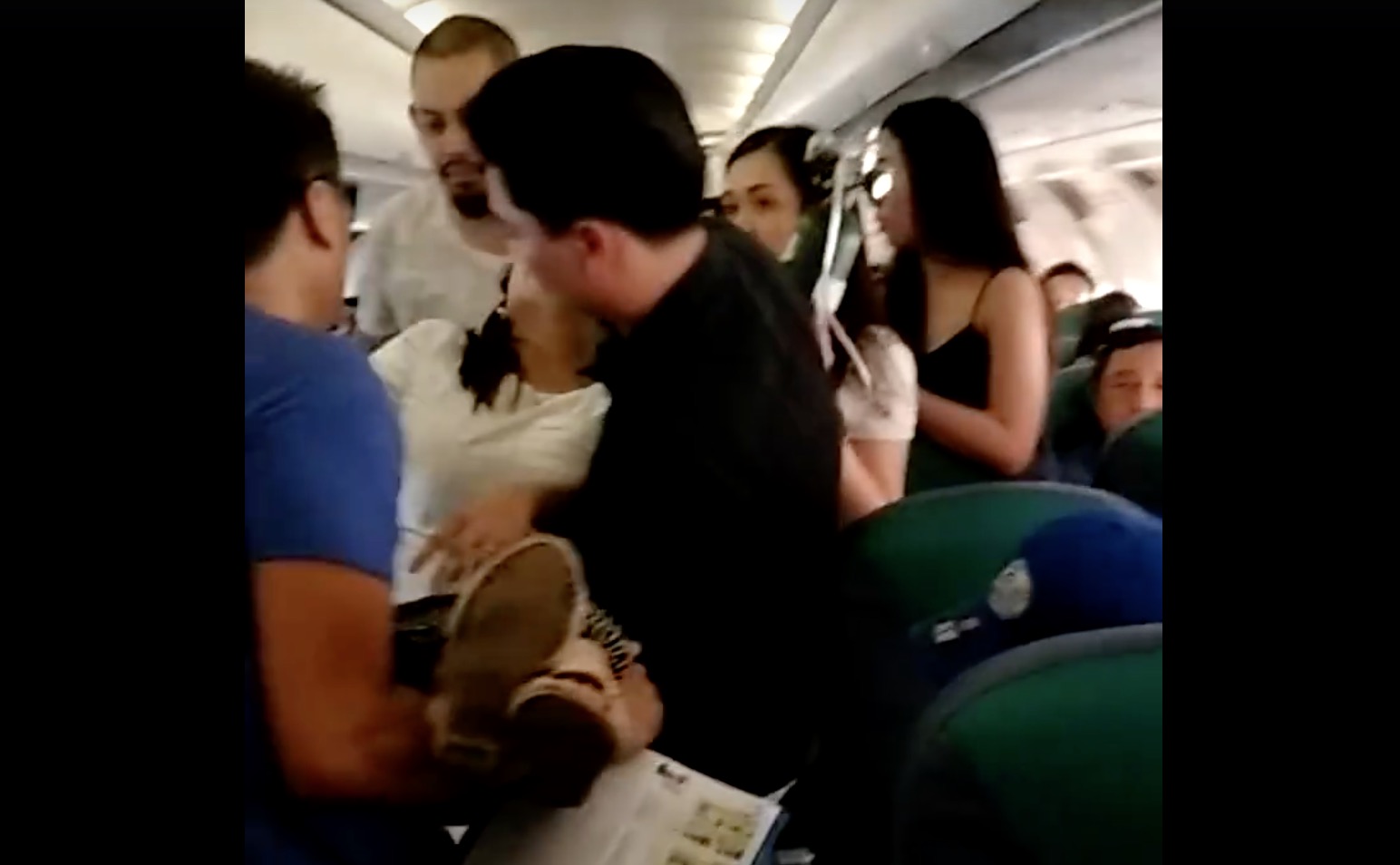 A woman passed out inside a “freakin’ hot” Cebu Pacific flight. PHOTO: Screengrab from Gin Durano’s Facebook video