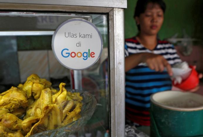 A sticker reading ‘Review us on Google’ is pictured at a food stall in Jakarta, Indonesia June 15, 2017. REUTERS/Agoes Rudianto