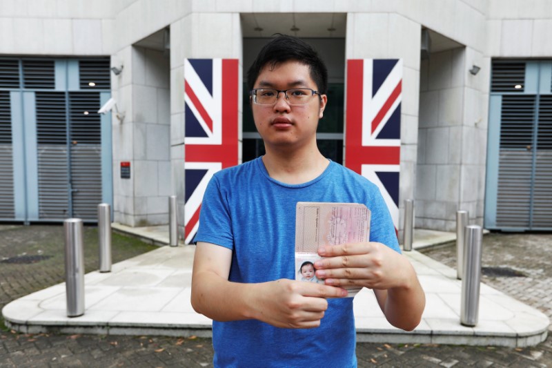 Wilson Li, who was born five months before Hong Kong’s handover to Chinese rule in 1997, poses with his British national (Overseas) passport issued in 1997, outside the British Consulate-General, in Hong Kong, June 15, 2017.  Photo: Tyrone Siu/Reuters