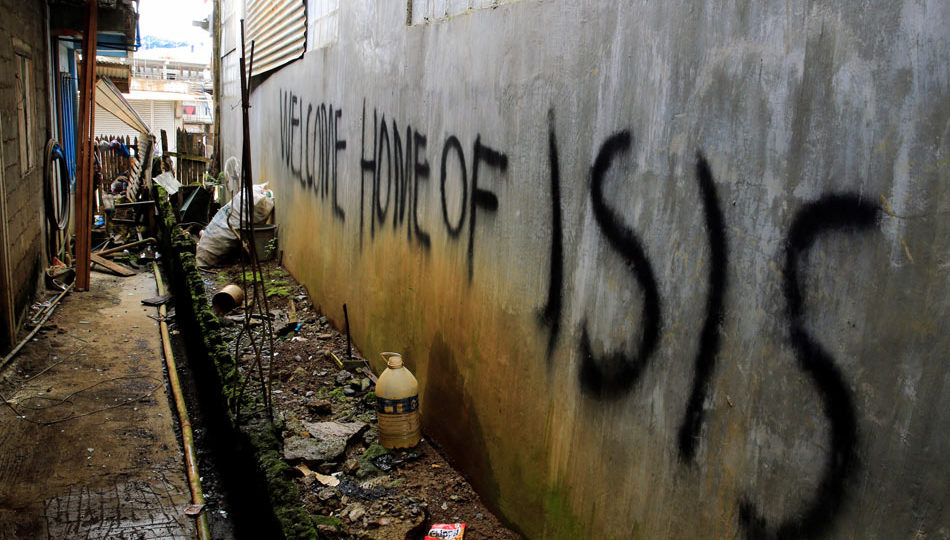 A graffiti is seen on a wall of a back-alley as government soldiers continue their assault against the Maute group in Marawi City, Philippines June 12, 2017. Romeo Ranoco, Reuters
