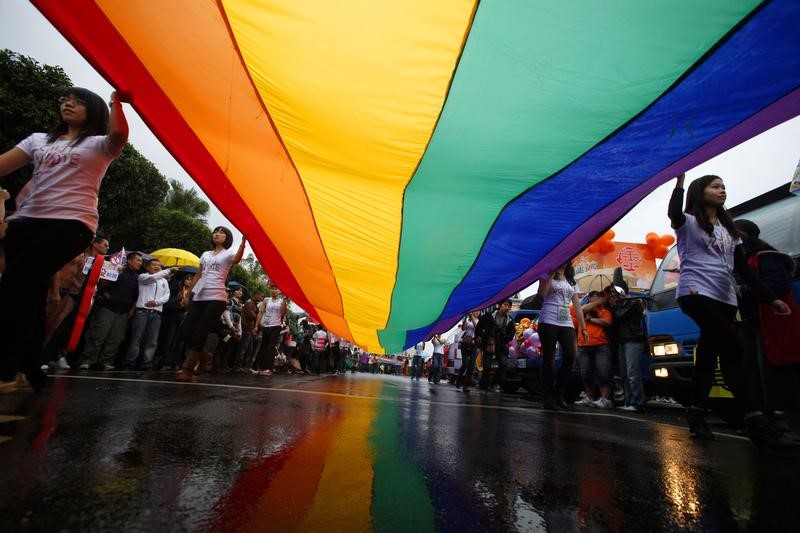 Participants hold a giant rainbow flag during the Taiwan Gay Pride Parade in Taipei October 30, 2010. Around 10,000 Taiwanese gathered with people from Malaysia, Korea and Japan on Saturday for the annual gay pride parade which is in its eighth year, according to organisers.    REUTERS/Nicky Loh