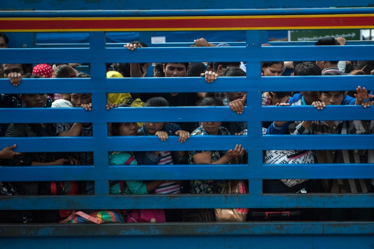 Migrant workers arriving in an official service truck from Thailand at the Myanmar immigration office in Myawaddy. Photo: AFP / Ye Aung THU