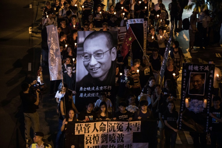 Thousands march in Hong Kong for pro-democracy dissident Liu Xiaobo. PHOTO: AFP/Dale de la Rey