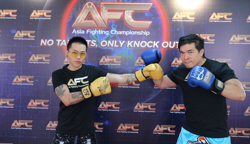 Is it us, or does Sylvester Sim look terribly bored next to Steven Lim’s forced fierceness? Photo: AFC 