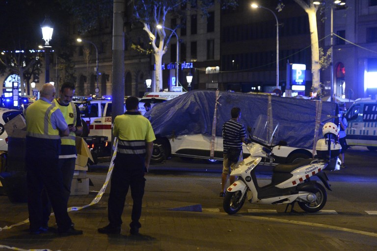 The van which ploughed into the crowd, killing at least 13 people and injuring around 100 others is towed away from the Rambla in Barcelona. Photo: Josep Lago / AFP