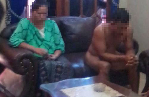 An uncredited photo supposedly showing GU, stripped of clothes, and his lover SU. Source:  Beritajatim (http://beritajatim.com/hukum_kriminal/306303/kepergok_selingkuh,_duda_ini_diarak_sambil_telanjang.html)